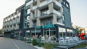 A multi-story building with a sign reading "Resort Wydma." - Wydma Resort (Trzebiatow)