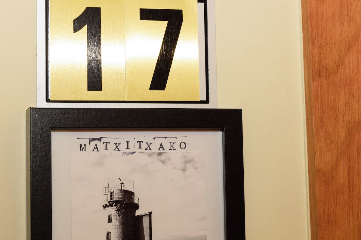 A framed photograph of a lighthouse with the number 17 above it.