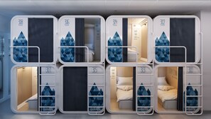 A row of bunk beds with geometric patterns, each labeled with a number. - Ostelzzz - Hostel (Milan)