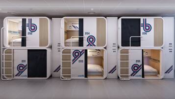 A row of bunk beds with numbers on the sides, each with a sign that says "Stay Connected" and a logo with the letter 'b'.