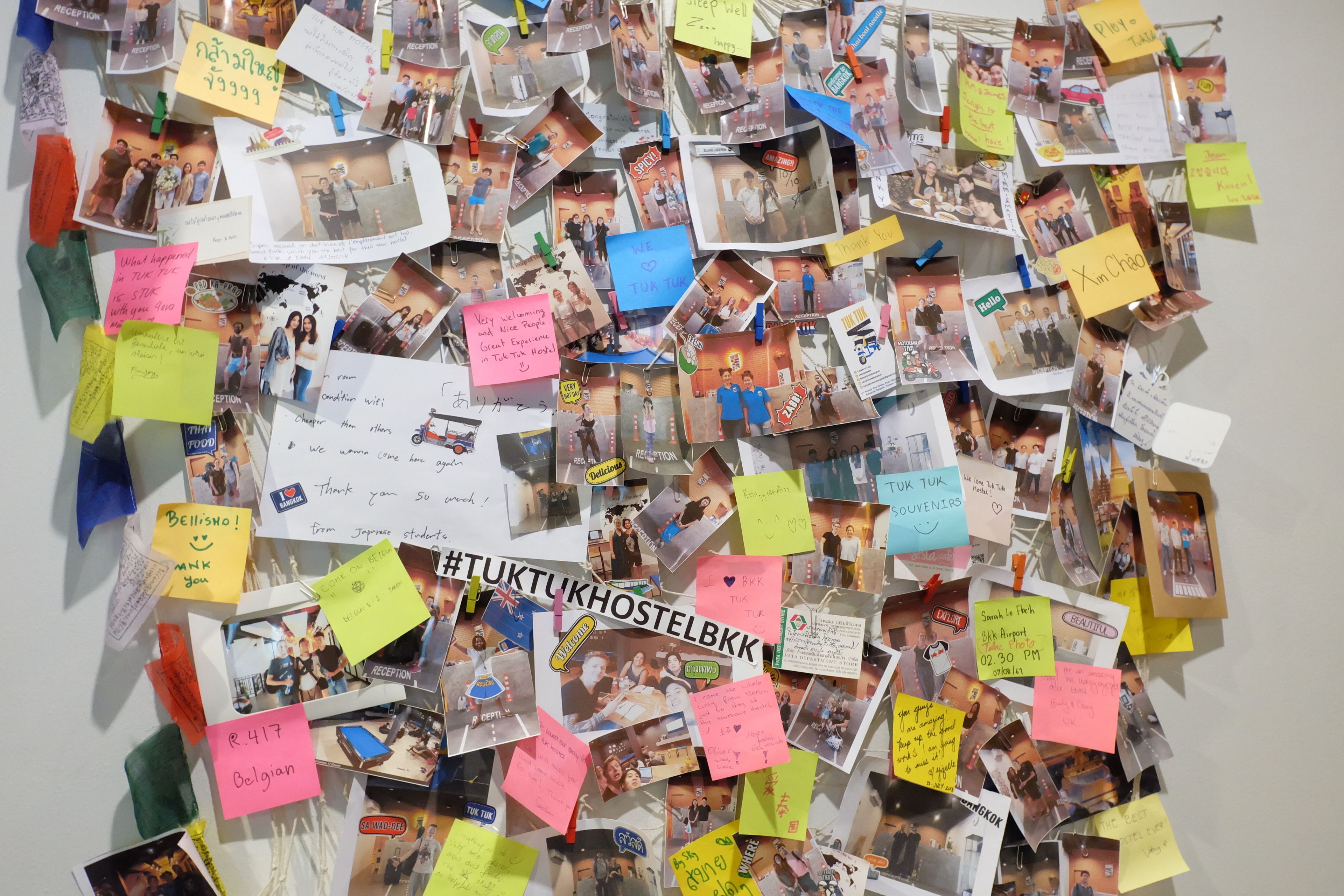 A wall covered with photos, notes, and various memorabilia, including a prominent hashtag.