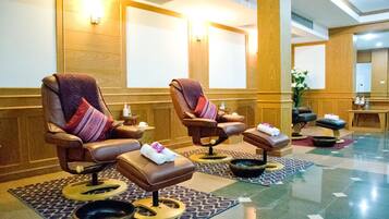 Relax in style with two plush massage chairs, complete with footrests and comfortable amenities.