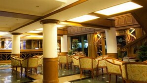 A spacious lobby with high ceilings, ornate columns, and a grand staircase. - Zaza Hotel (Samut Prakan)