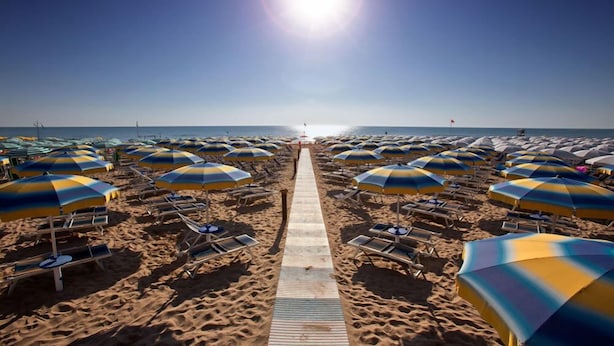 A beach with rows of sun umbrellas and lounge chairs. - Hotel Antares (Alba Adriatica)