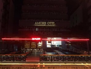 The exterior of Amore Hotel with a prominent red sign and a staircase leading to the entrance. - Amore Hotel (Marmaris)