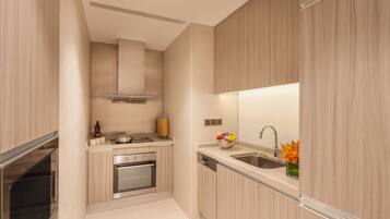 A modern kitchen with wooden cabinets, stainless steel appliances, and a built-in oven.