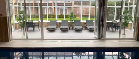 Indoor pool, open 7:00 AM to 8:00 PM, pool loungers