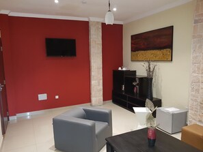 Deluxe Suite, 1 Bedroom | Living room | 40-inch flat-screen TV with cable channels, TV - Neila Hôtel Résidence (Sèmè-Kpodji)