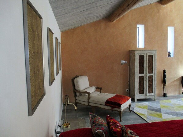 A room with a bed, a chair, a cabinet, and a lamp. - Le Mas Du Fort  (Gargas)