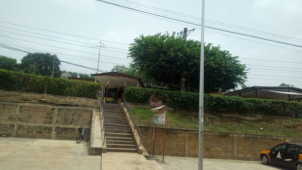 A staircase leading to a covered area with a bicycle parked nearby.
