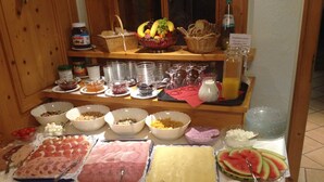 A buffet table with various food items and beverages.