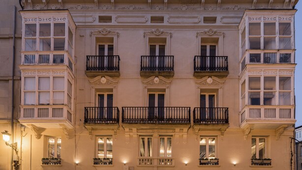 A multi-story building with ornate balconies and large windows. - Wine & Soul Suites (Haro)