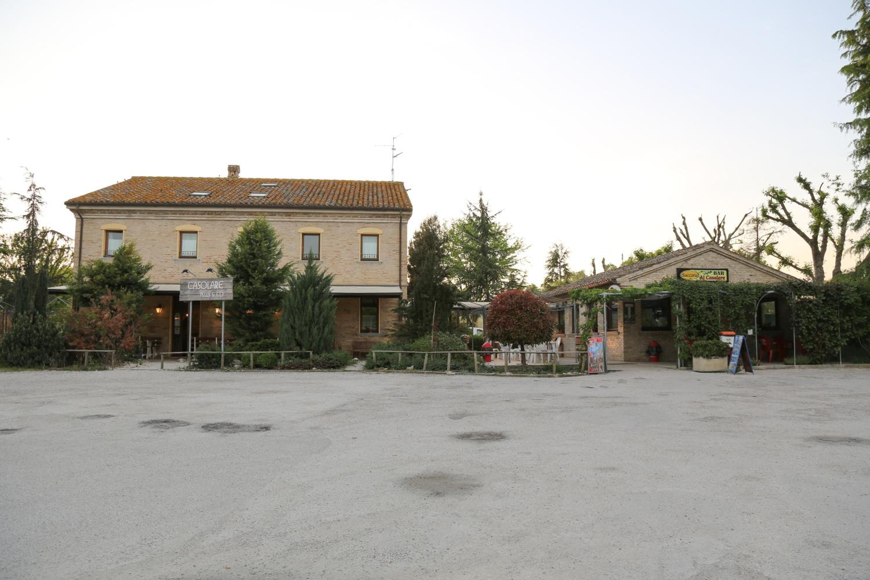 A building with a sign reading "CASOLARE" and a smaller structure with a sign that appears to say "BAR."