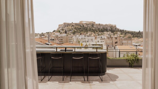 A balcony with a view of a historic hilltop cityscape, including ancient ruins. - Perianth Hotel, a member of Design Hotels (Athens)