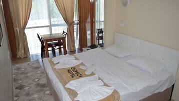 Relax in comfort with a large bed, decorative headboard, and a neatly made bedspread.