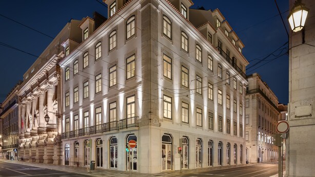 A historic building with multiple stories, large windows, and a classic architectural style. - Residentas Aurea (Lisbon)