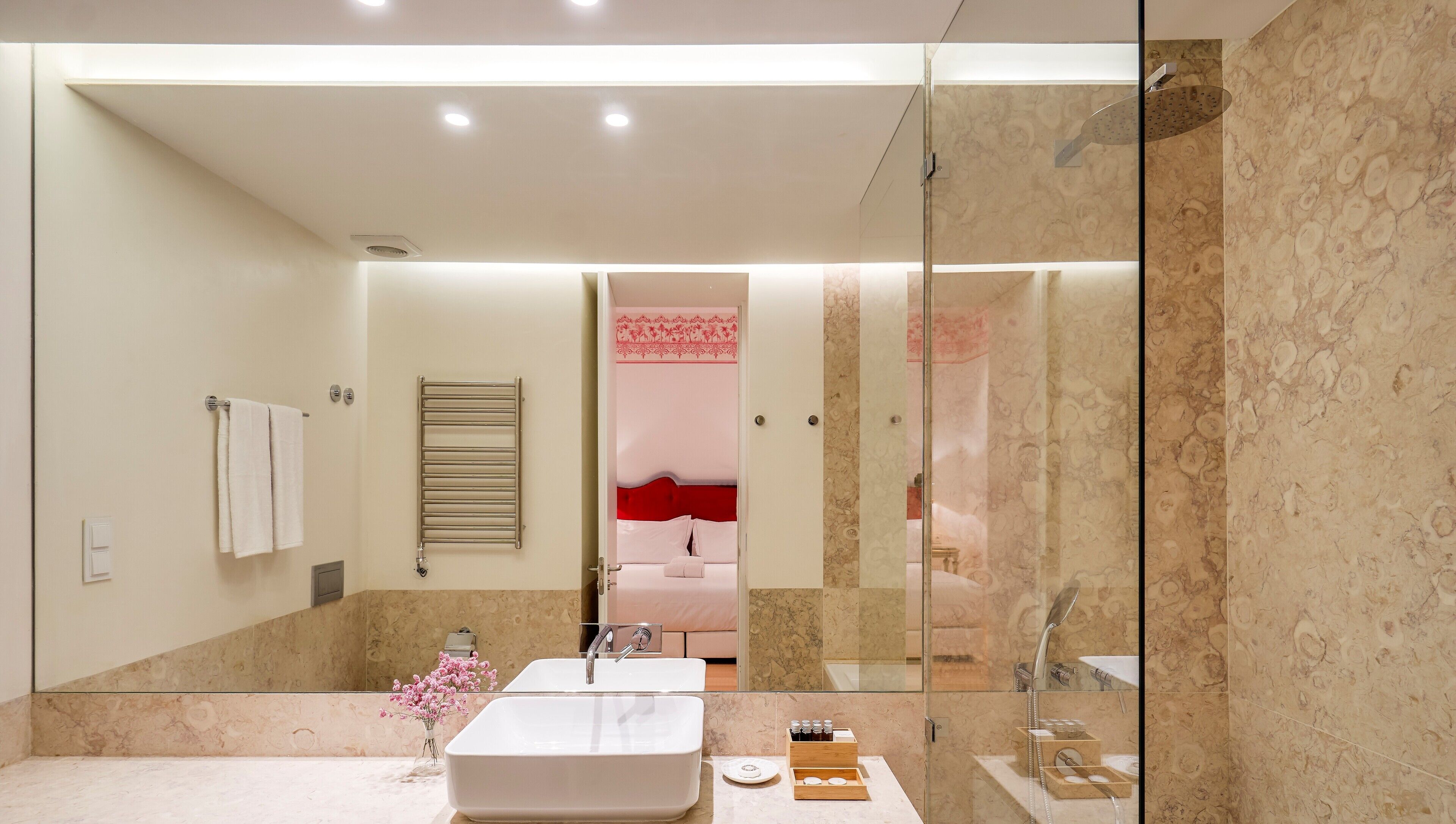 A modern bathroom with a large mirror, a bathtub, and a shower.