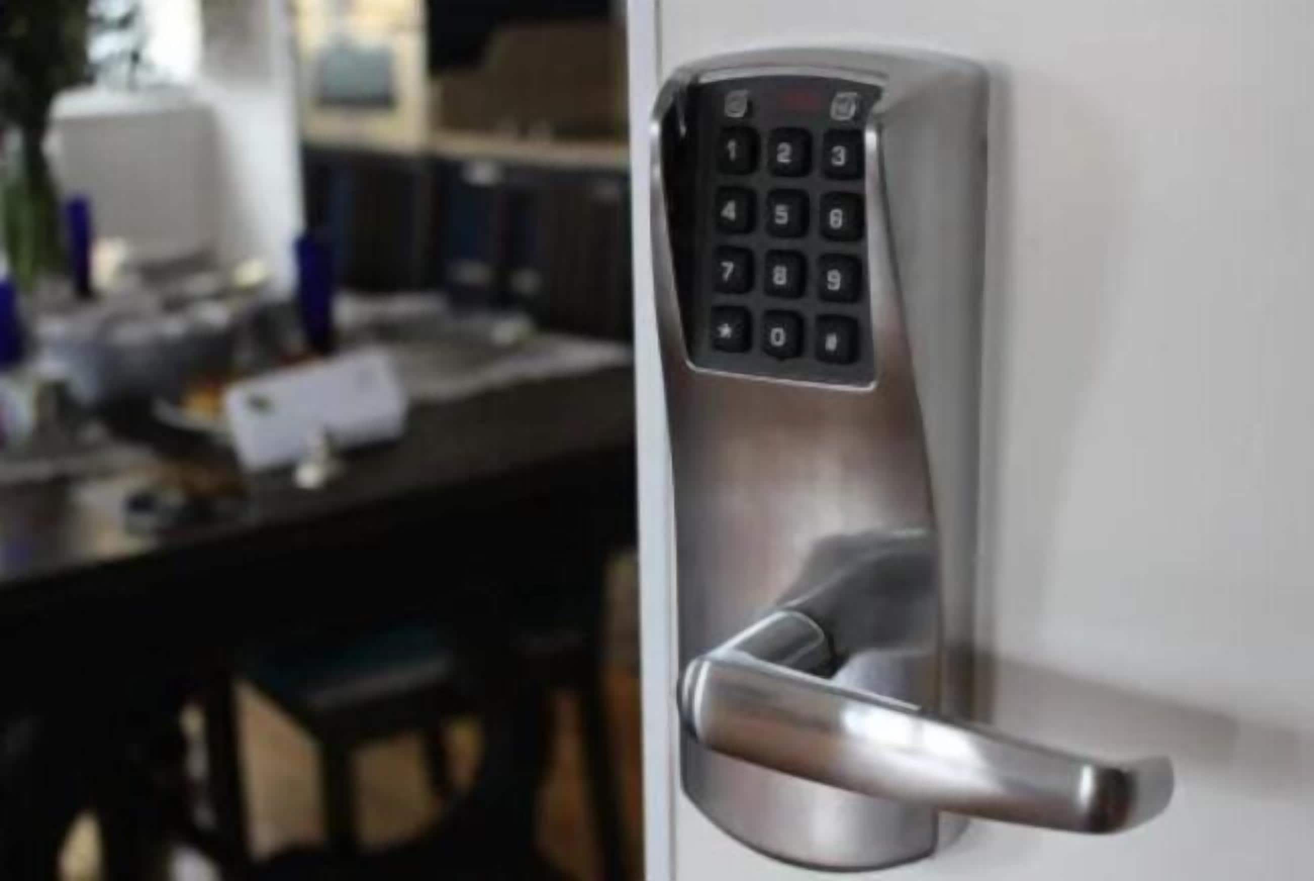 A modern door with a numeric keypad lock.