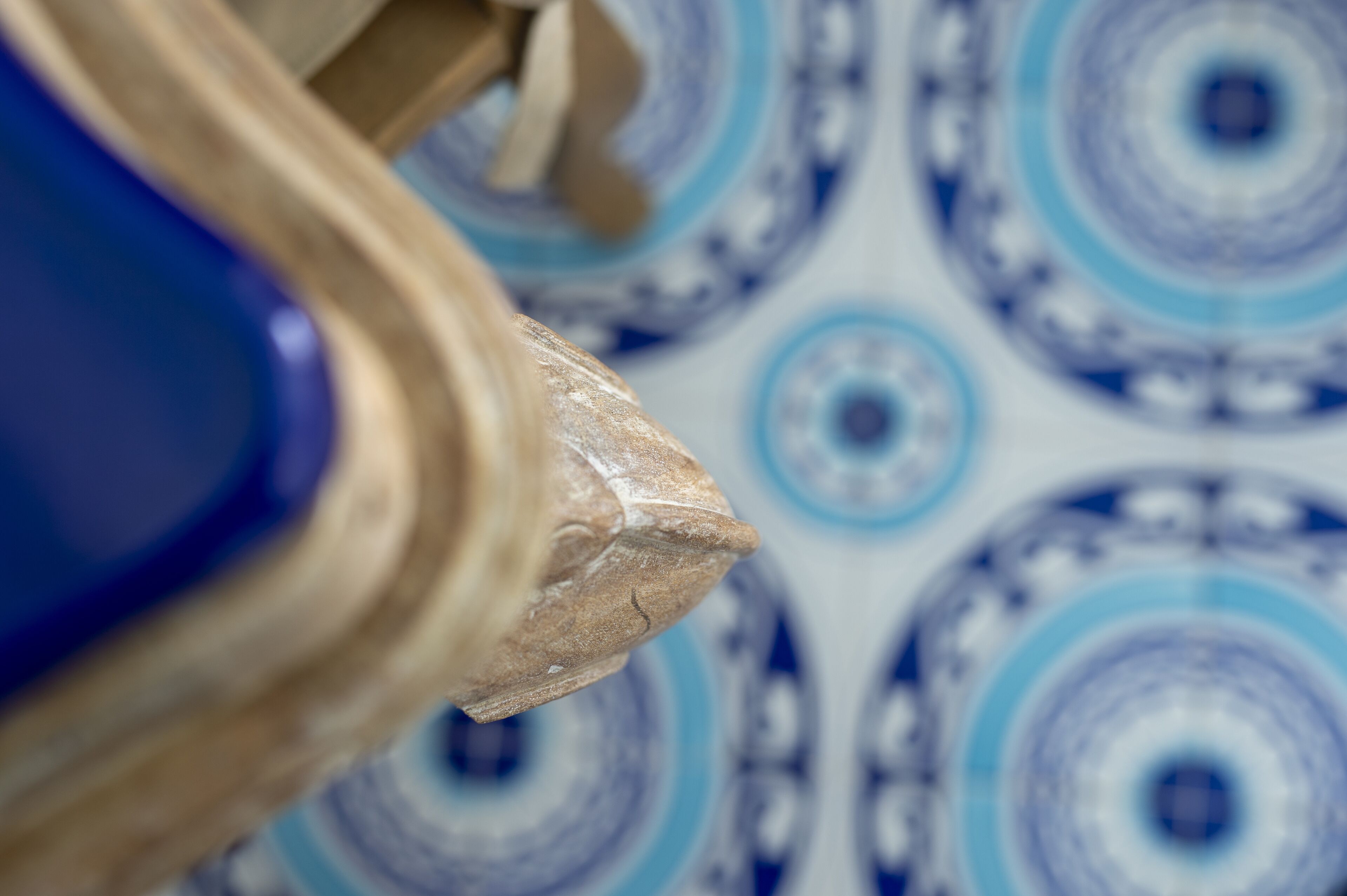 A close-up of a blue and white patterned tile with concentric circles.
