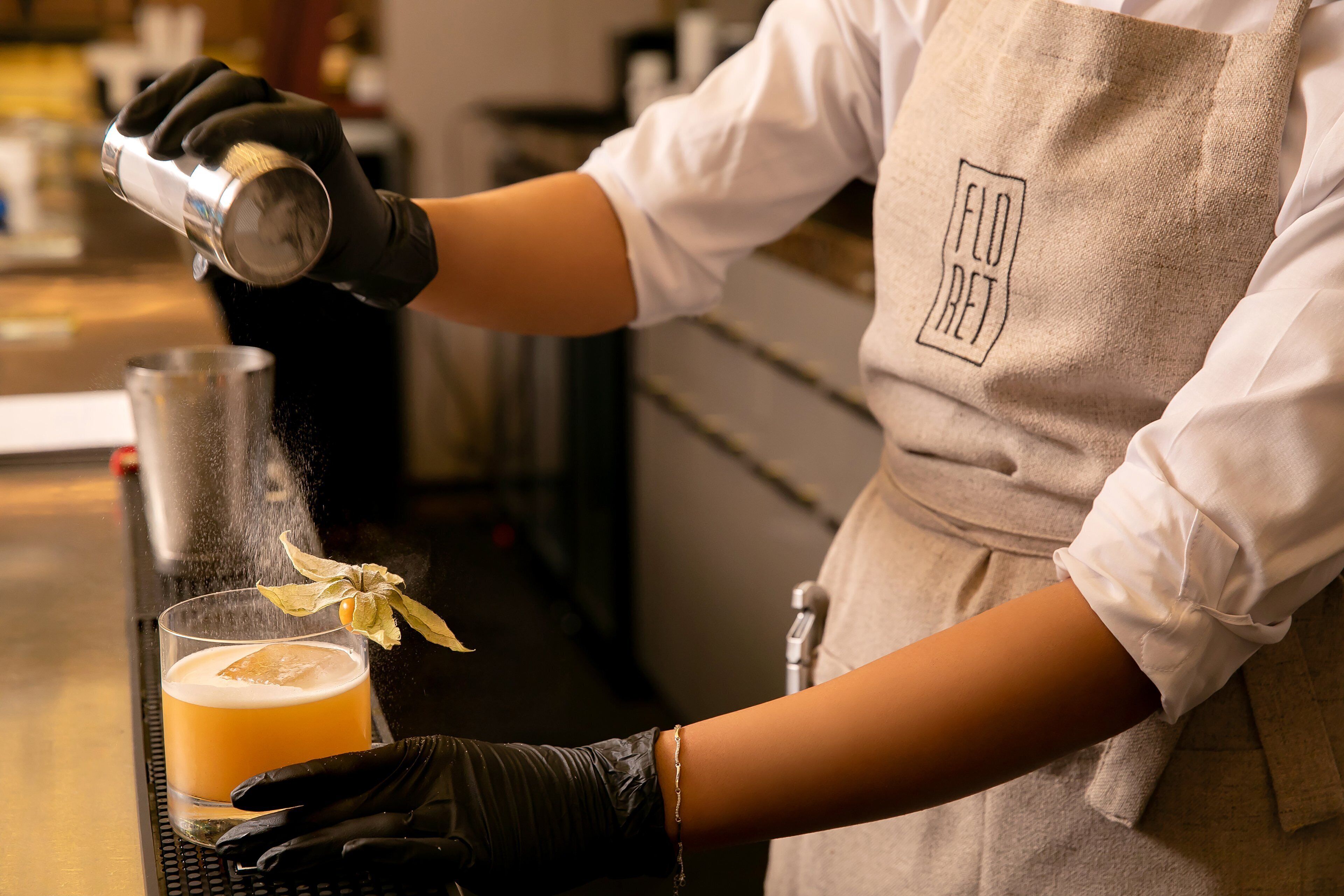 A person pouring a drink into a glass.