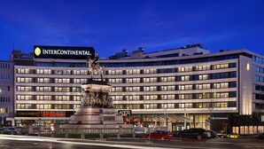 A hotel with a large statue in front, multiple floors, and a prominent InterContinental sign. - InterContinental Sofia by IHG (Sofia)