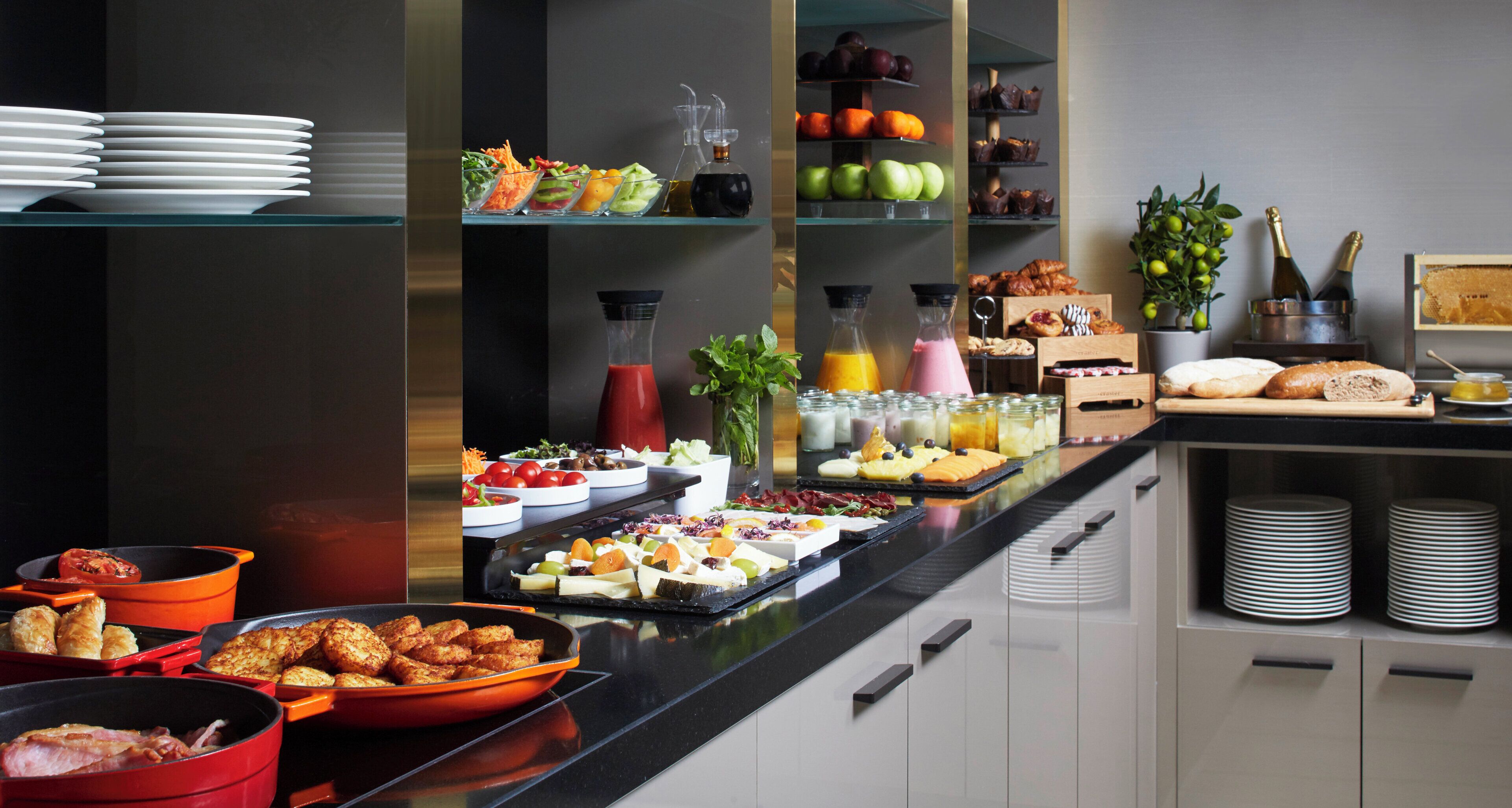 A buffet with various food items and beverages.