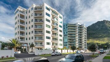 Stunning hotel with curved and straight lines, offering panoramic views of the surrounding hills.