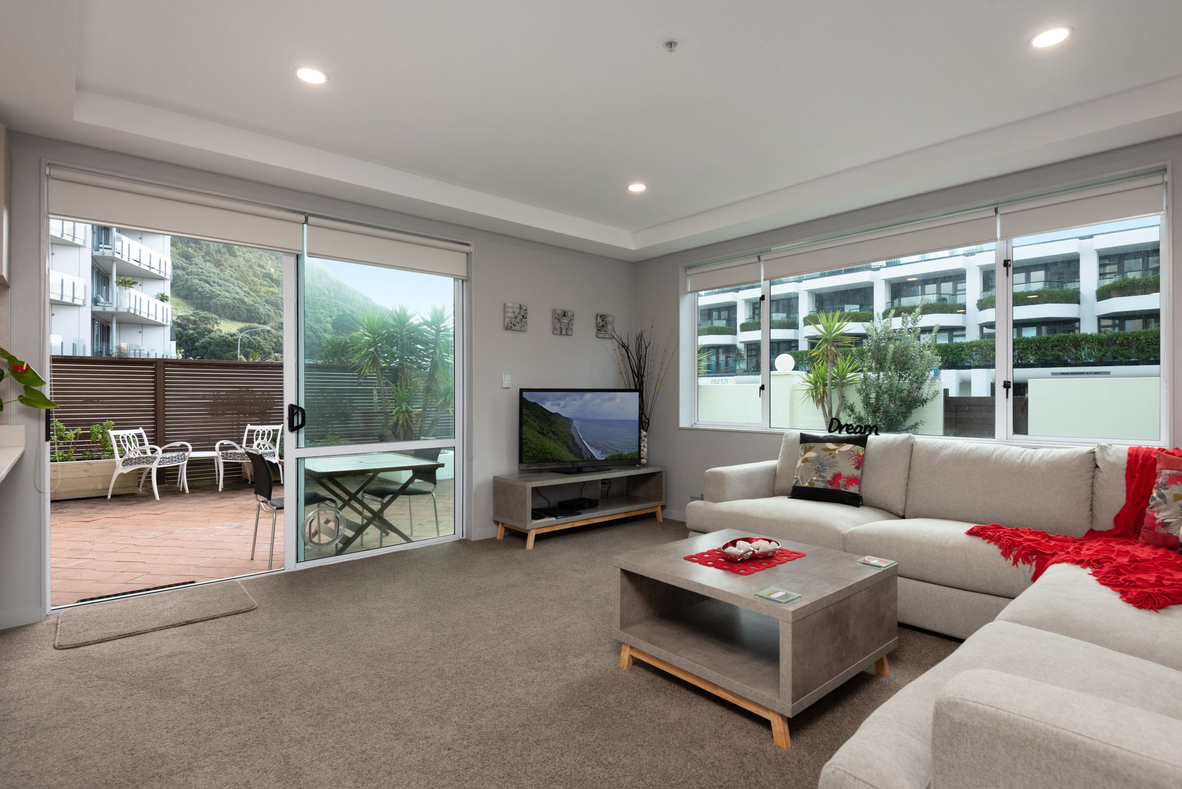 one bedroom courtyard apartment | living area | flat-screen tv