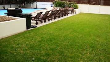 Seasonal outdoor pool, open 9:00 AM to 9:00 PM, pool loungers