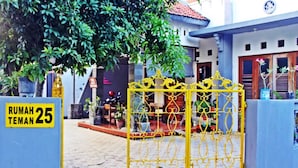 A gated entrance to a property with a sign indicating room number 25.
