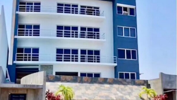 A multi-story building with a modern architectural design, featuring balconies and large windows. - Depa Torre Marina (Mazatlán)