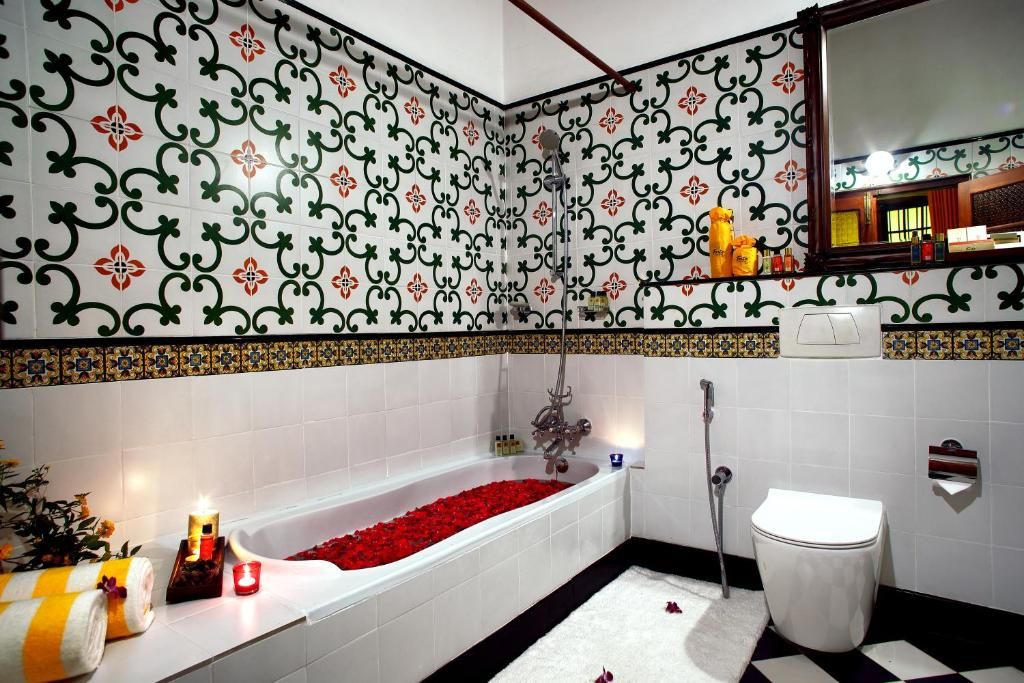 A bathroom with a bathtub, toilet, and shower.