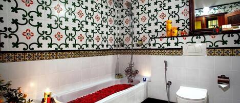 A bathroom with a bathtub, toilet, and shower.