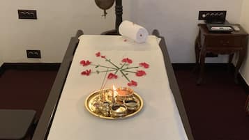 Experience a serene atmosphere in this tranquil retreat, featuring a massage table, candles, and a peaceful ambiance.