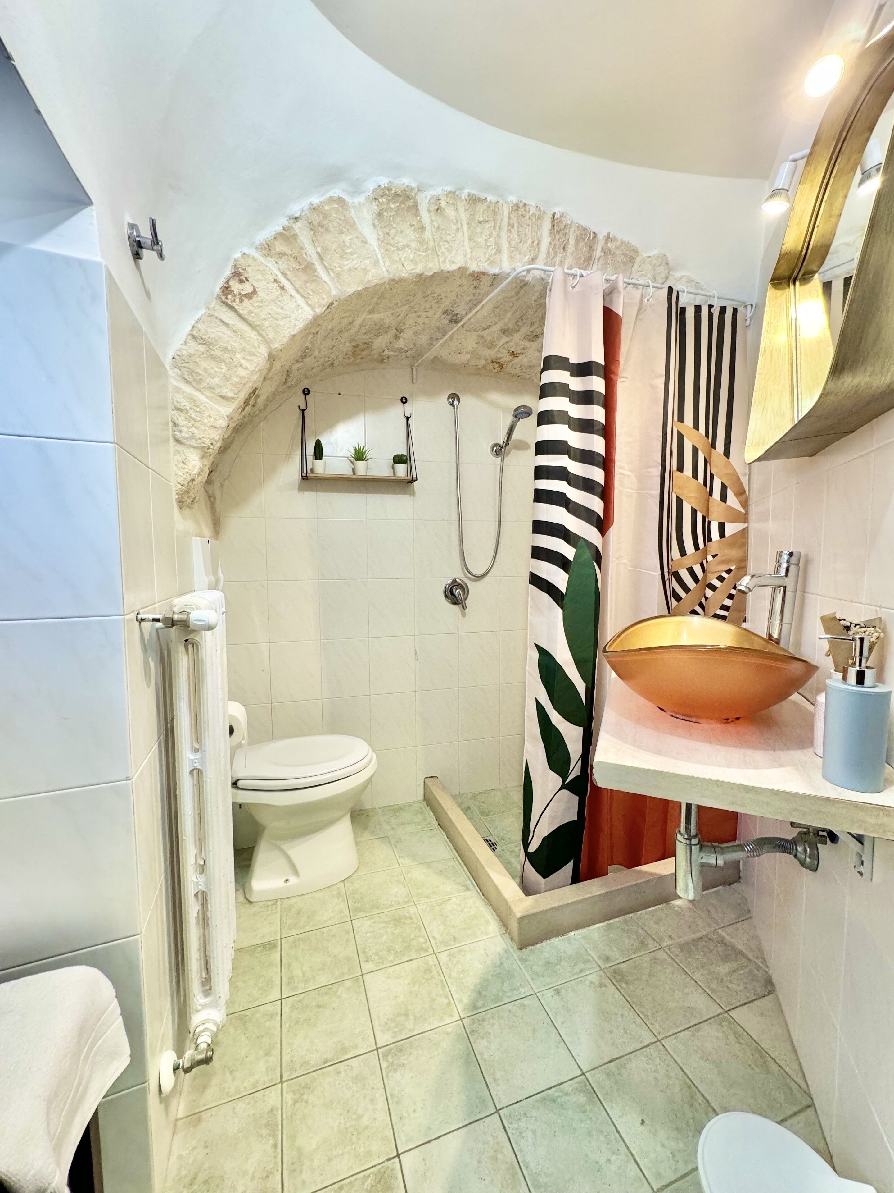 A bathroom with a shower, toilet, and sink.