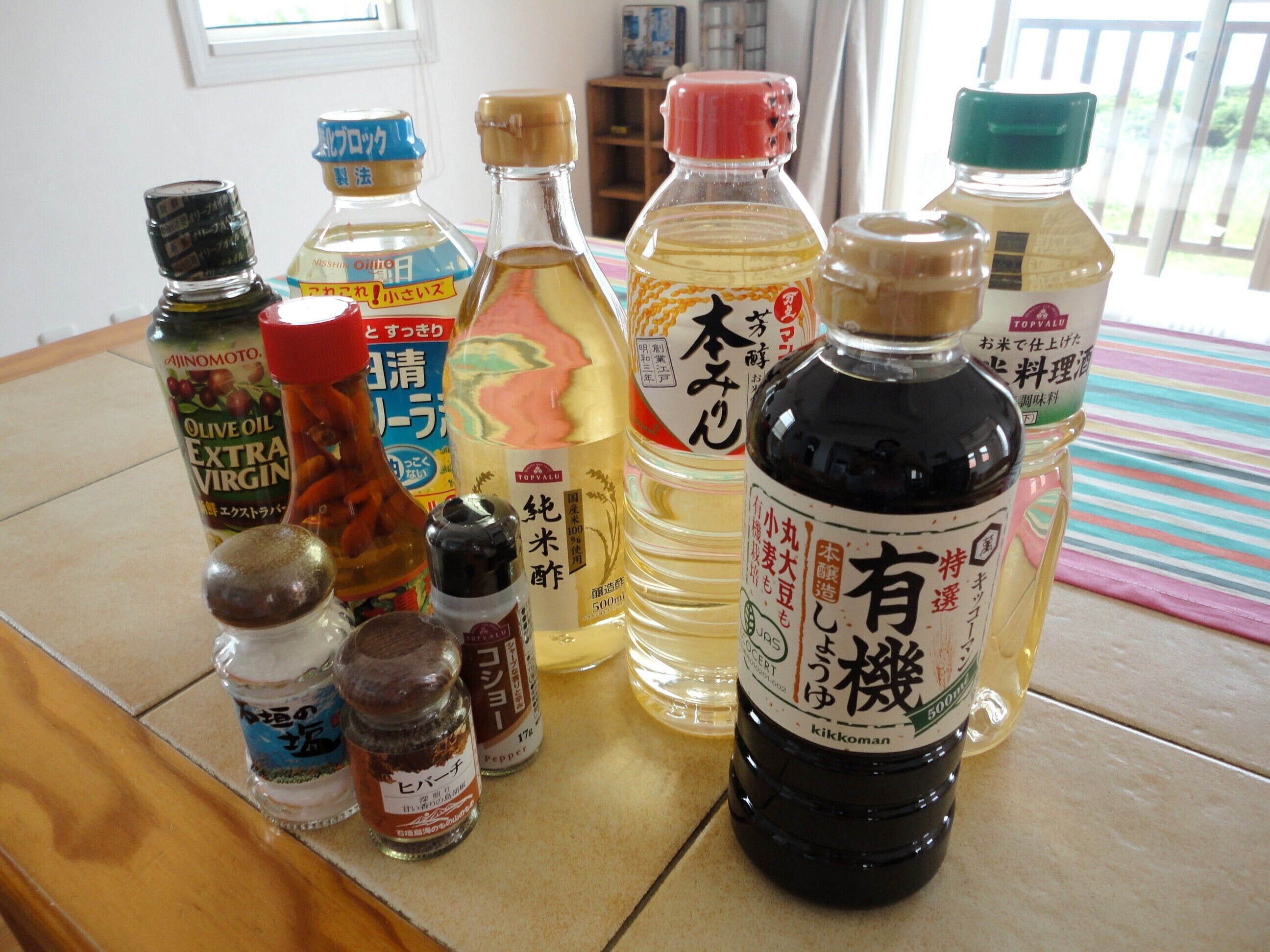 A variety of condiment bottles on a table.