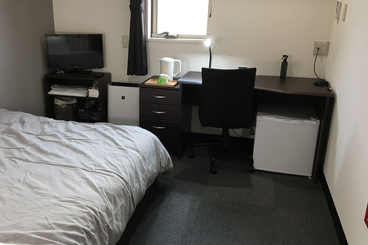 Premium bedding, desk, laptop workspace, soundproofing