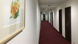 A hallway with a red carpet, white walls, and framed artwork on the left. - Yadomaru Mine Non Smoking (Mine)