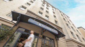 A hotel entrance with a sign reading "Hotel Rudy" and a number "36" above the door. - myNext - Hotel Rudy (Vienna)