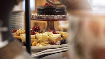 A dessert display with various cakes and pastries.