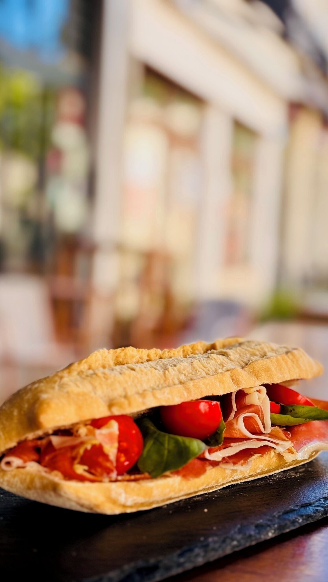 A sandwich on a slate board.