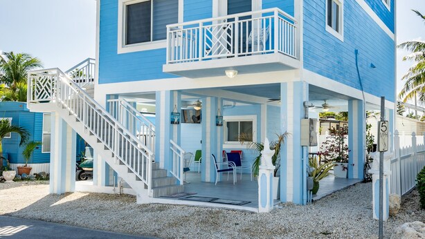 A two-story building with balconies and a covered porch. - Brand New Key Largo Home (Key Largo)