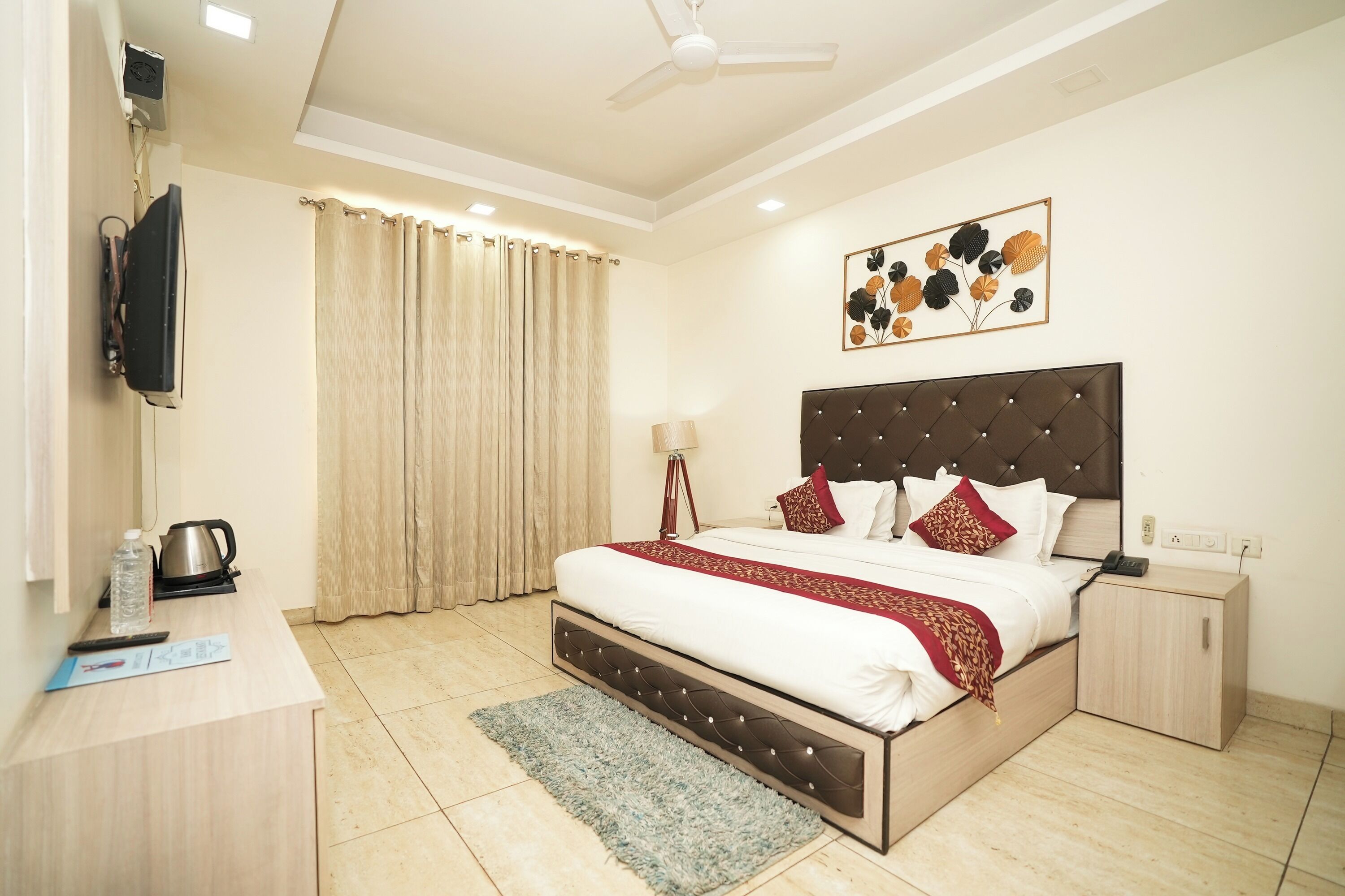 A neatly arranged bedroom with a bed, bedside table, and a desk.