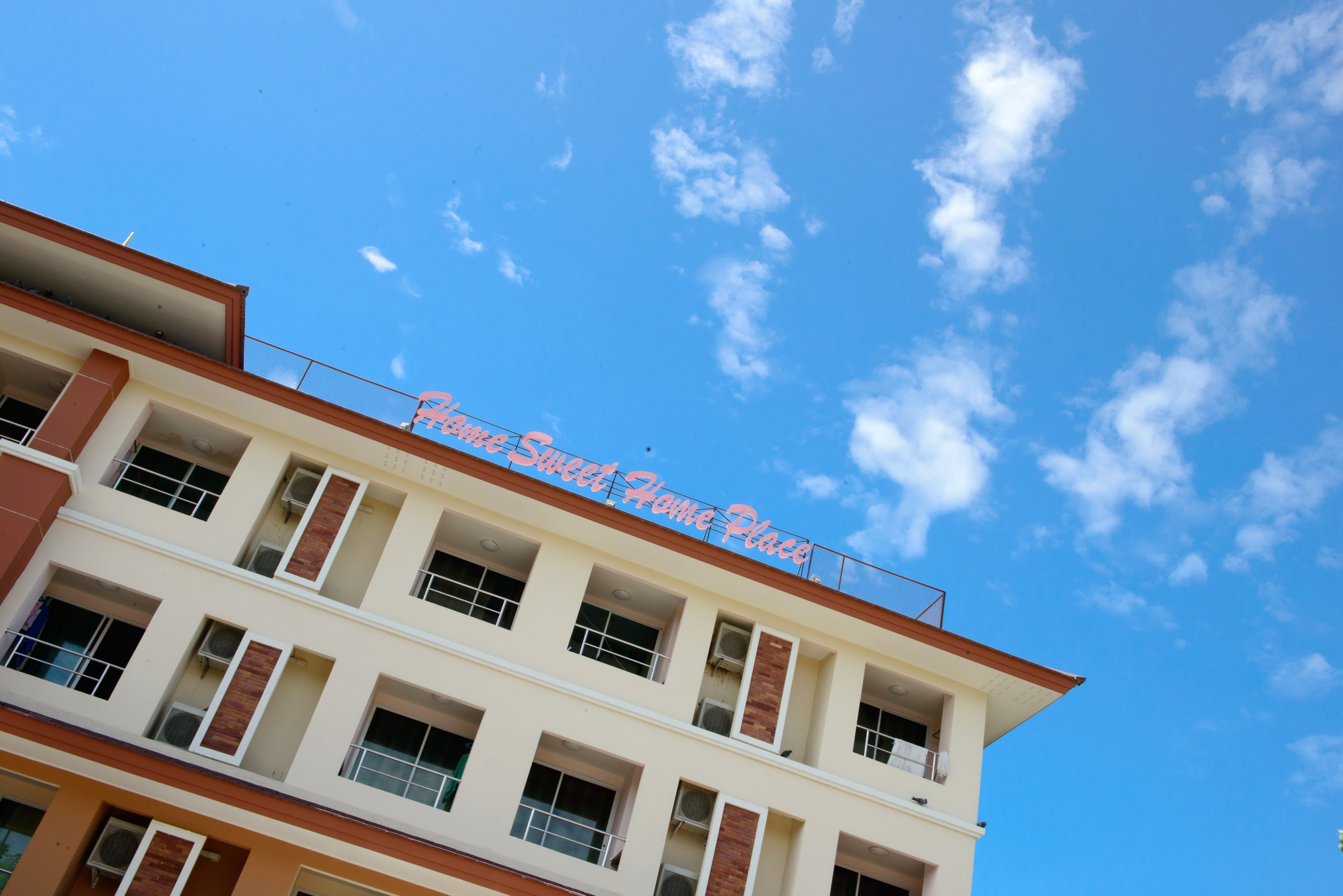 A multi-story building with a sign reading "Sweet Home Place".