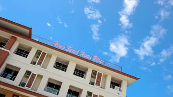 A multi-story building with a sign reading "Sweet Home Place".