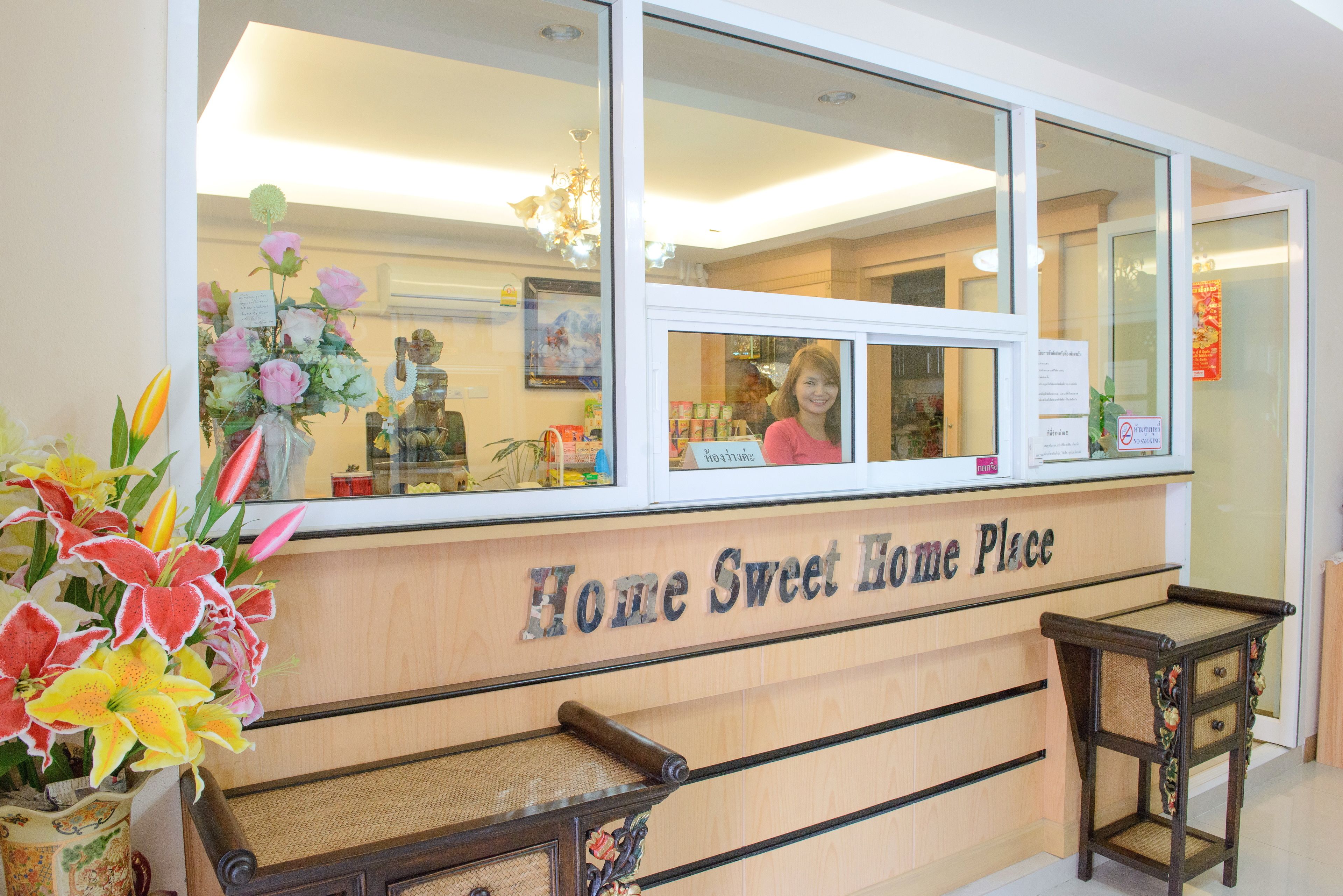 A reception desk with a sign reading "Home Sweet Home Place".