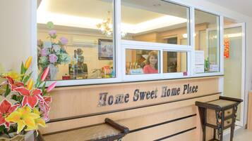 A reception desk with a sign reading "Home Sweet Home Place".