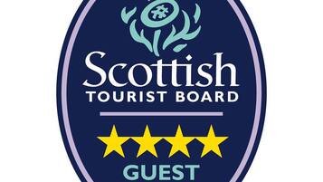 A logo for the Scottish Tourist Board with a five-star rating and the words "Guest House" below it.