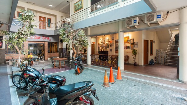 A multi-level indoor space with a gym, seating area, and a staircase.