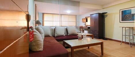 A living room with a sofa, a coffee table, and a cabinet.